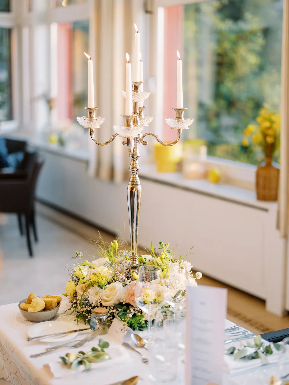 Elegant wedding table centerpiece with tall candelabra at a French Riviera reception - detail by wedding photographer French Riviera.