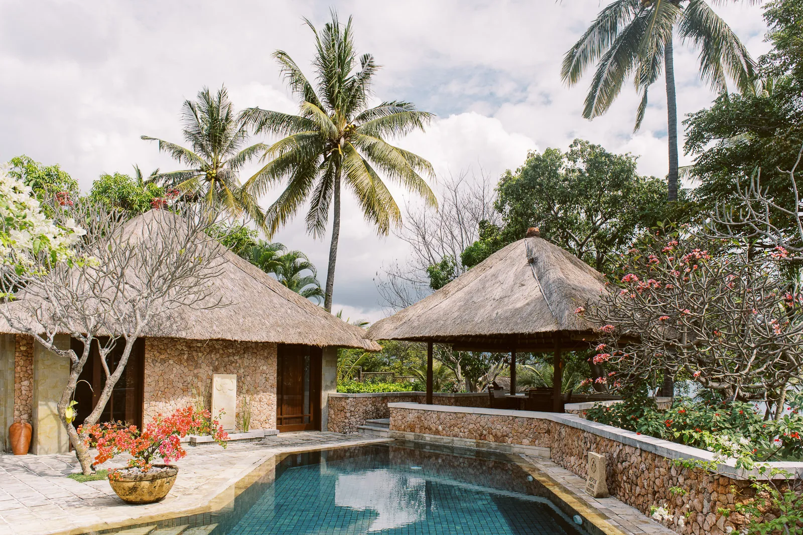 Beautiful Lombok villa with thatched roofs, stone walls, and private pool - venue shot by wedding photographer Lombok.