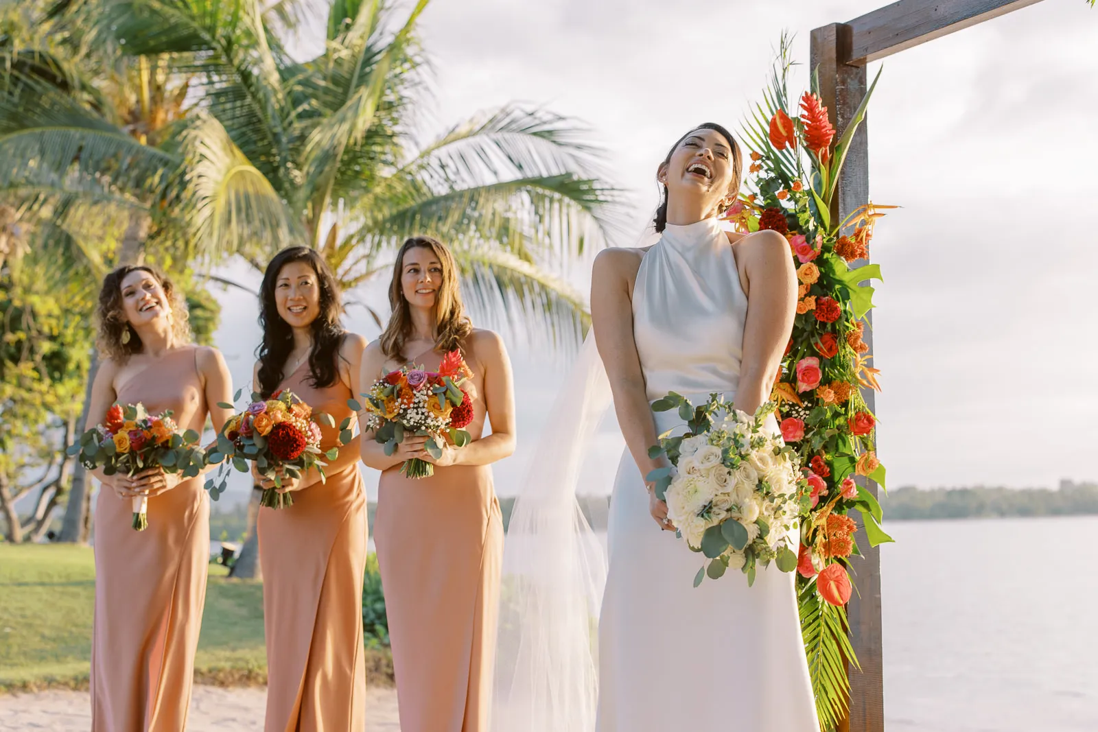 Bride laughing heartily with her bridesmaids during beach ceremony in Lombok - photo by wedding photographer Lombok.