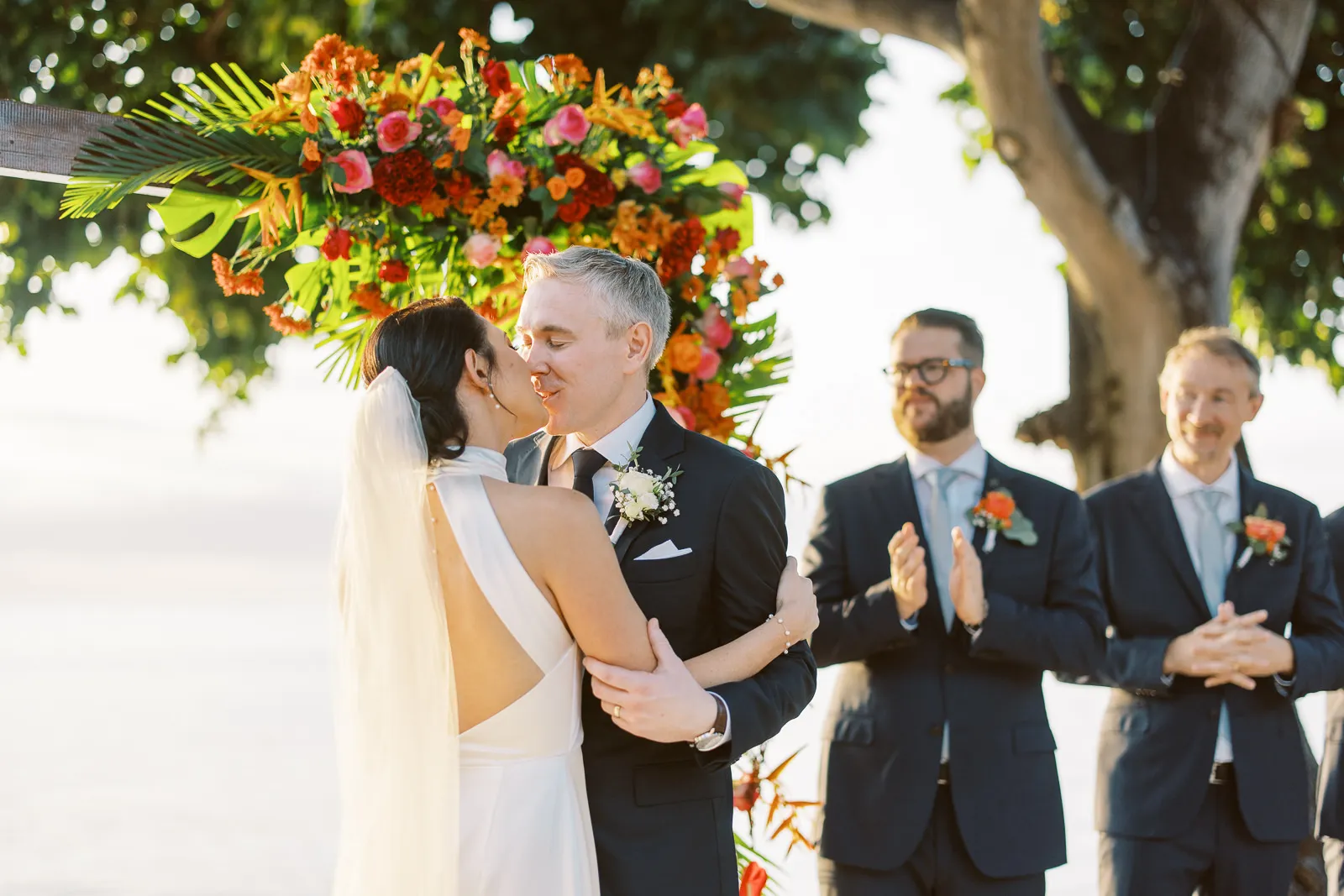 Bride and groom share their first kiss at the altar during their Lombok beach wedding - photo by wedding photographer Lombok.