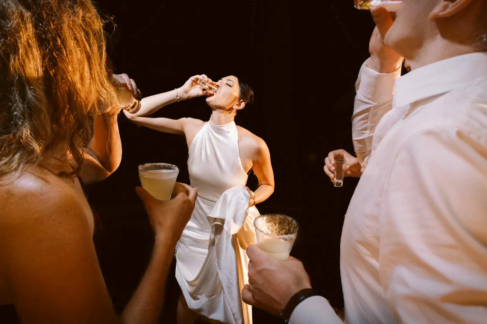 Bride taking a shot with guests during her lively Lombok wedding reception party - photo by wedding photographer Lombok.