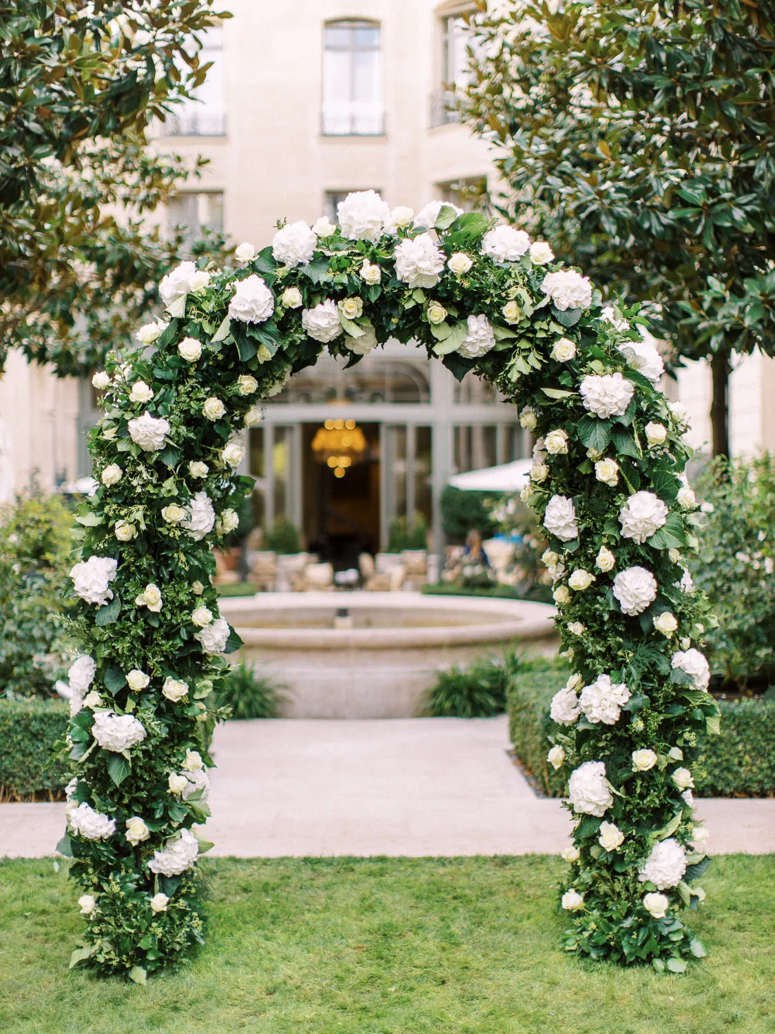 Beautiful white hydrangea and rose floral arch in the garden of the Ritz Paris - wedding decor by Wedding photographer Ritz Paris.