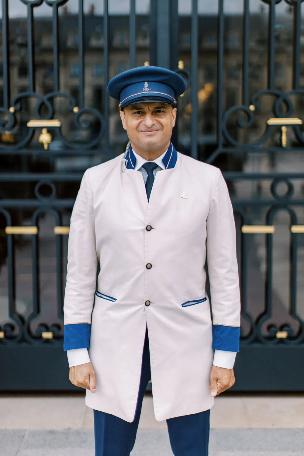 Portrait of a distinguished Ritz Paris doorman in iconic uniform - captured by Wedding photographer Ritz Paris. Photographe mariage Ritz Paris
