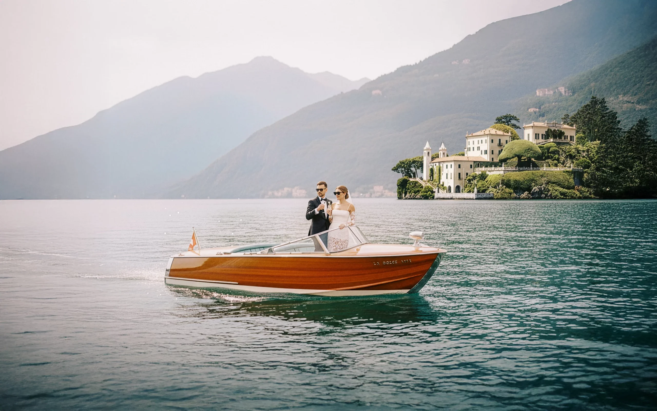 Elegant couple on a classic wooden boat celebrating on Lake Como, captured by a wedding photographer Lake Como.