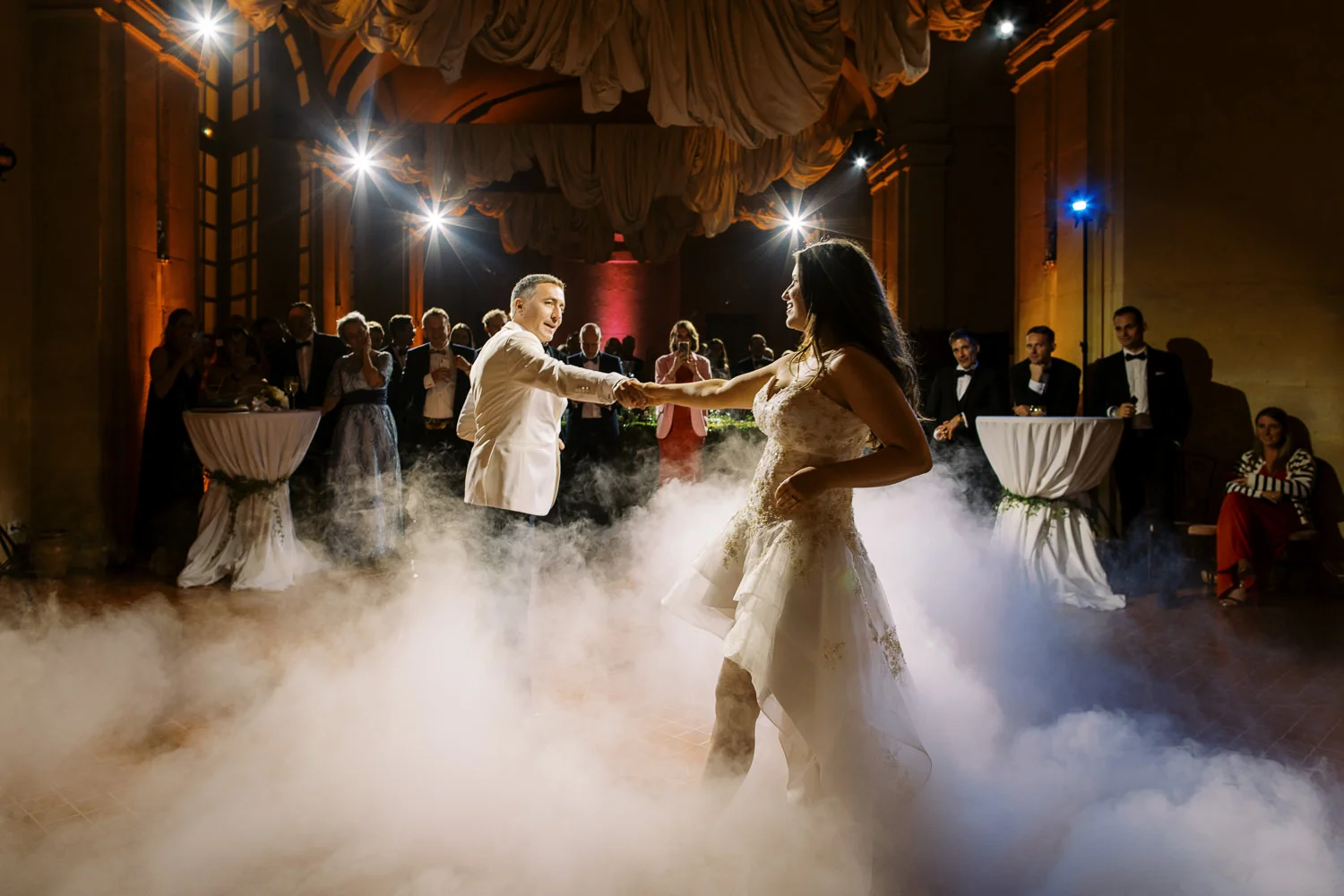 Joyful bride and groom dancing on a smoke-filled floor, captured by a Wedding photographer Lake Como.