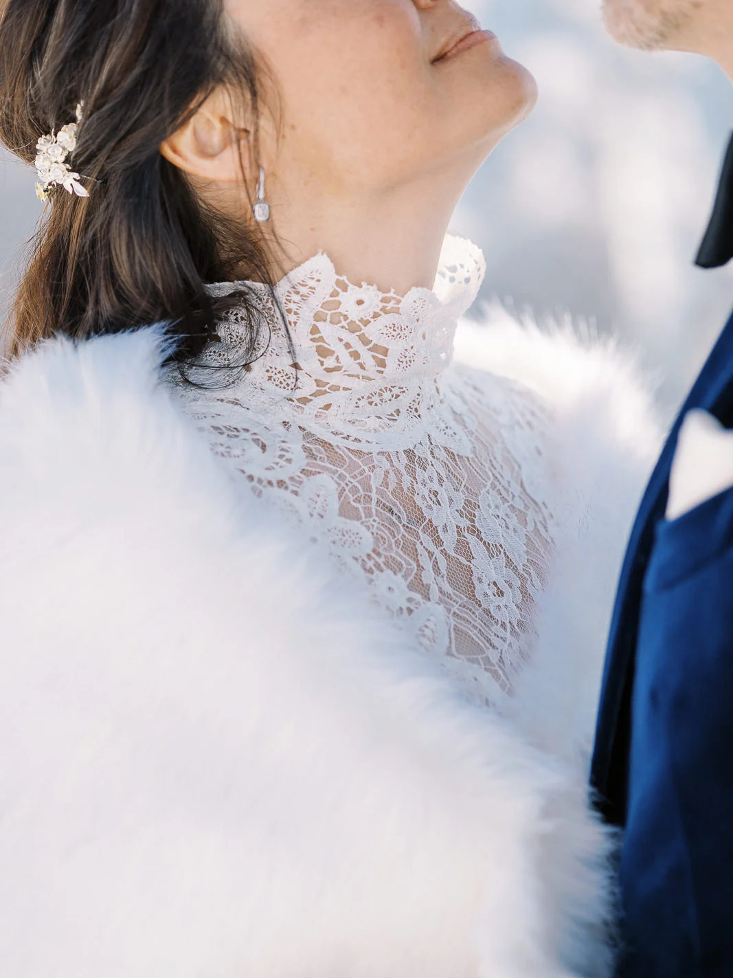 Elegant bride in white lace and fur, captured by a Wedding photographer French Alps.