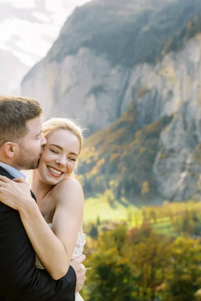 Bride and groom embracing in a mountain valley by a french wedding photographer.