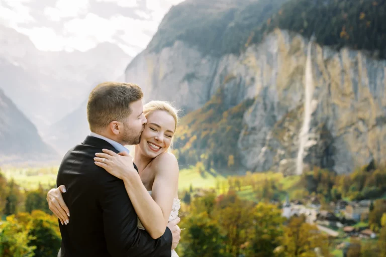 Bride and groom embracing in a mountain valley by a french wedding photographer wedding photographer.