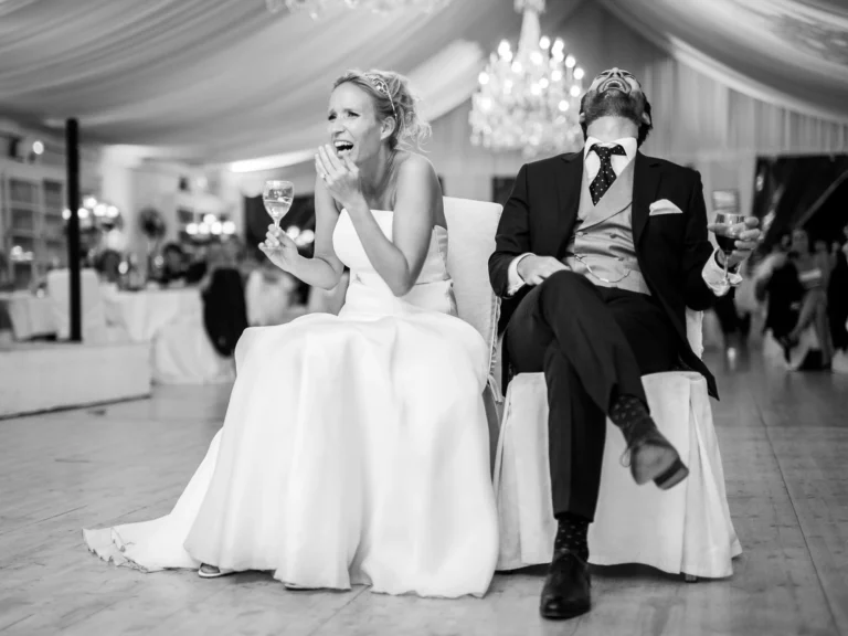 Joyful bride and groom laughing during their reception, captured by a french wedding photographer wedding photographer.