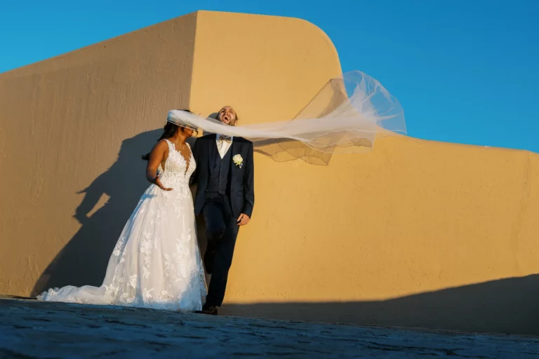 Candid bride and groom moment with blowing veil by a French wedding photographer wedding photographer.