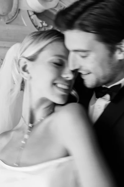 Intimate blurred portrait of a joyful couple captured by a professional French wedding photographer.