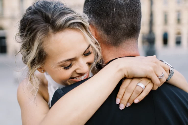 A joyful bride embracing her groom during a luxury session with a French wedding photographer.