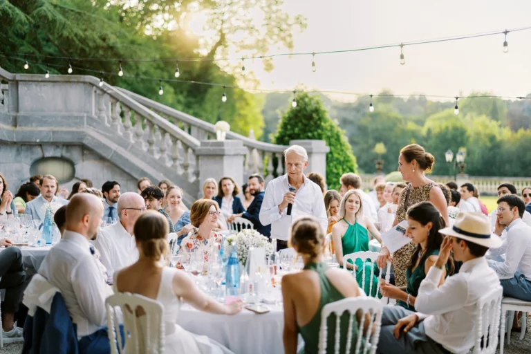 Wedding speech at an outdoor dinner by a french wedding photographer wedding photographer during golden hour.
