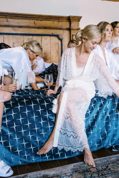 Bride and bridesmaids in silk robes during morning preparation by a French wedding photographer.