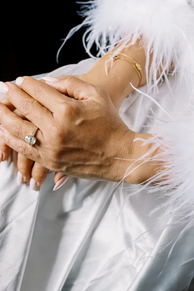 Detail of bride's hands with pear-shaped diamond ring captured by a French wedding photographer.