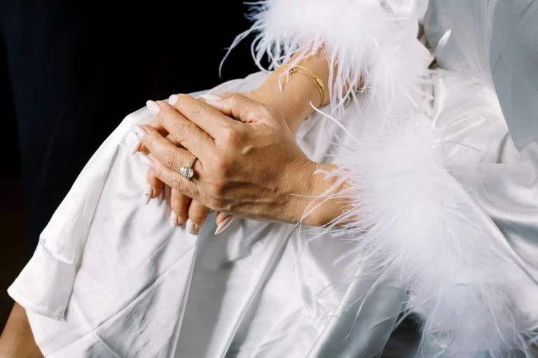 Detail of bride's hands with pear-shaped diamond ring captured by a French wedding photographer.