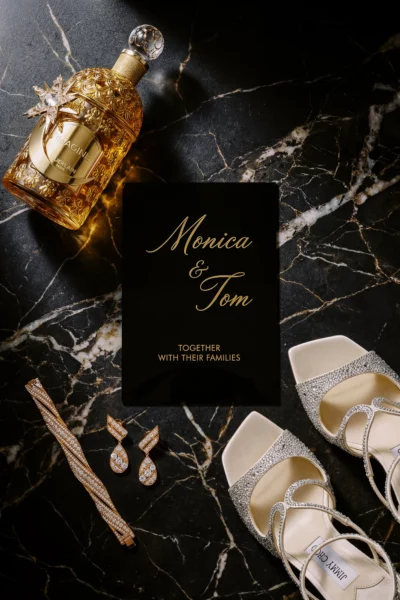 Luxury bridal accessories flat lay captured by a French wedding photographer on dark marble.