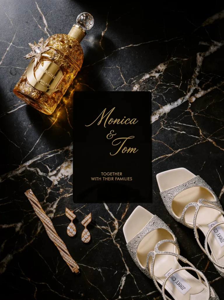 Luxury bridal accessories flat lay captured by a French wedding photographer wedding photographer on dark marble.