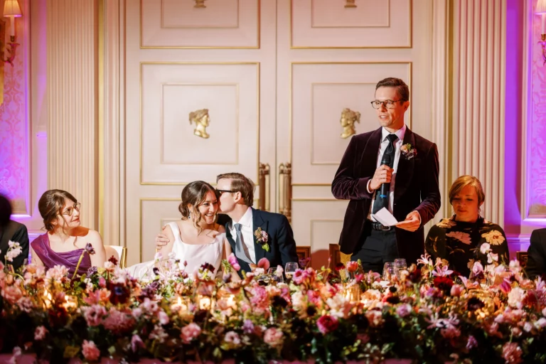 Emotional dinner speeches captured by a french wedding photographer in a luxury ballroom setting.