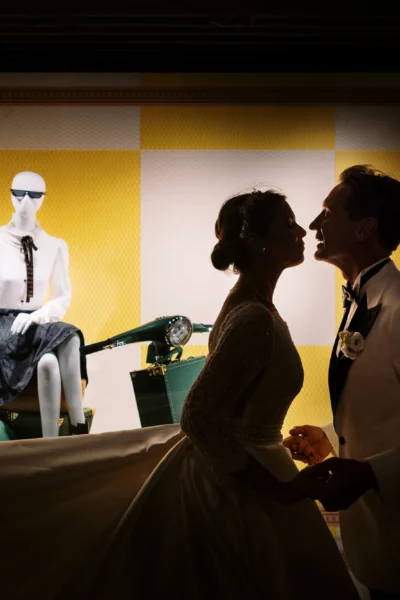 Silhouette of a bride and groom by a french wedding photographer at a luxury storefront.