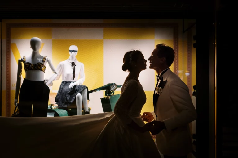 Silhouette of a bride and groom by a french wedding photographer wedding photographer at a luxury storefront.