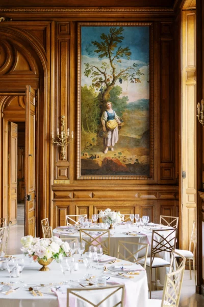 Elegant reception tables in a luxury chateau ballroom captured by a French wedding photographer.