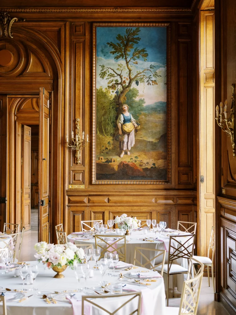Elegant reception tables in a luxury chateau ballroom captured by a French wedding photographer.