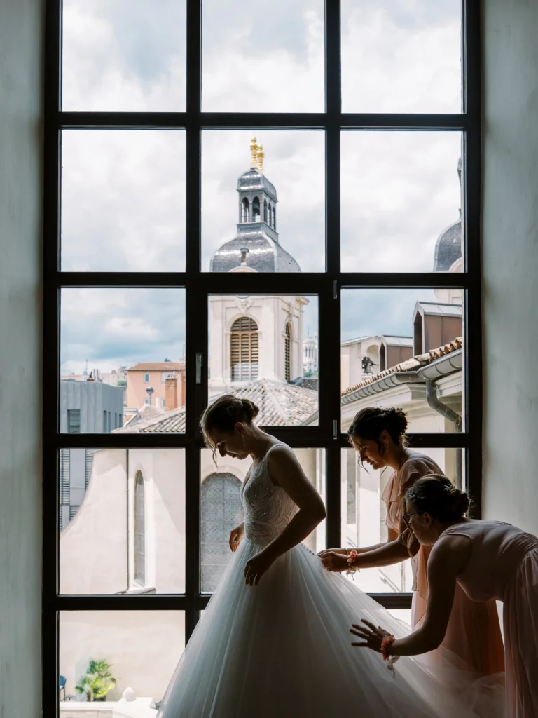 A bride getting ready in a luxury suite by a French wedding photographer in Lyon.