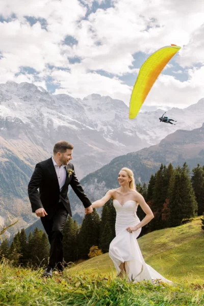 Bride and groom running in the Alps captured by a French wedding photographe.
