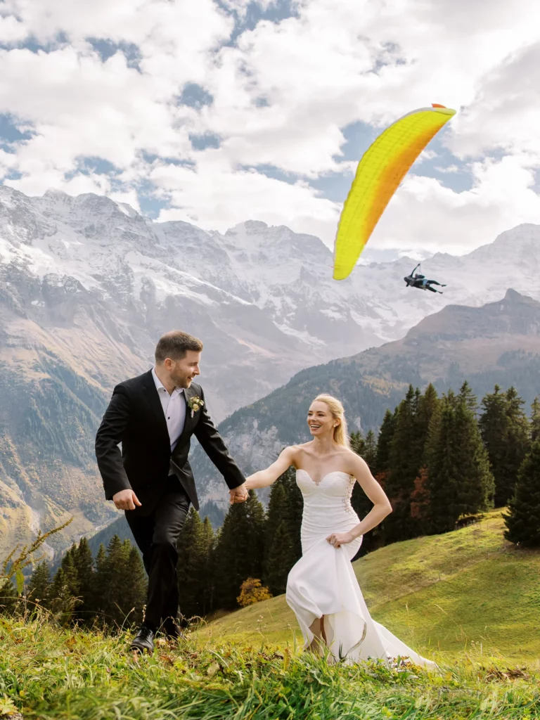 Bride and groom running in the Alps captured by a French wedding photographer wedding photographer.