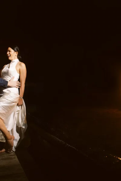 A bride and groom laughing at night, captured by a French wedding photographer.