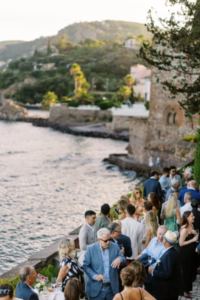 Elegant seaside wedding cocktail hour captured by a European wedding photographer at golden hour.