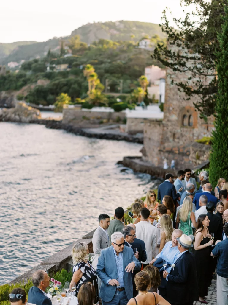 Elegant seaside wedding cocktail hour captured by a European wedding photographer at golden hour.