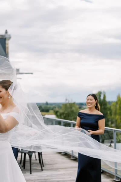 Bride with flowing veil on a chateau terrace by a european wedding photographer.