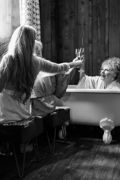 Champagne toast during bridal preparations captured by a French wedding photographer in a luxury chalet suite.