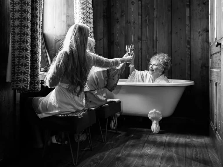 Champagne toast during bridal preparations captured by a French wedding photographer in a luxury chalet suite.