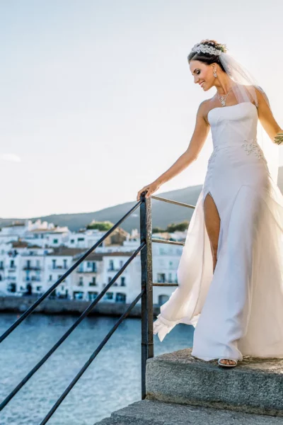 Elegant bride walking coastal stairs captured by a french wedding photographer.