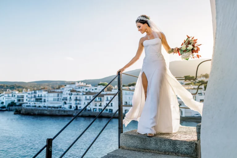 Elegant bride walking coastal stairs captured by a french wedding photographer.