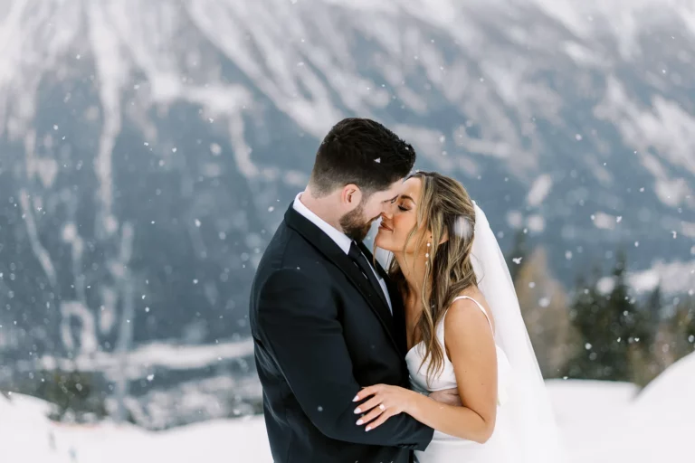 Bride and groom embrace in the snowy Alps captured by a french wedding photographer.