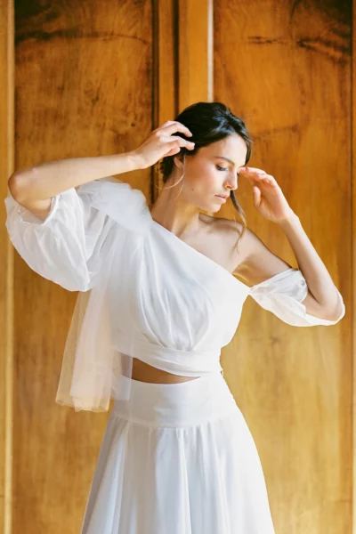 Bride in modern two-piece gown captured by a French wedding photographer in a chateau.