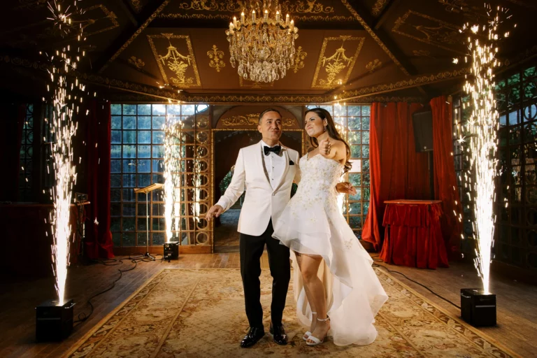 Bride and groom celebrate with indoor sparklers, captured by a french wedding photographer.