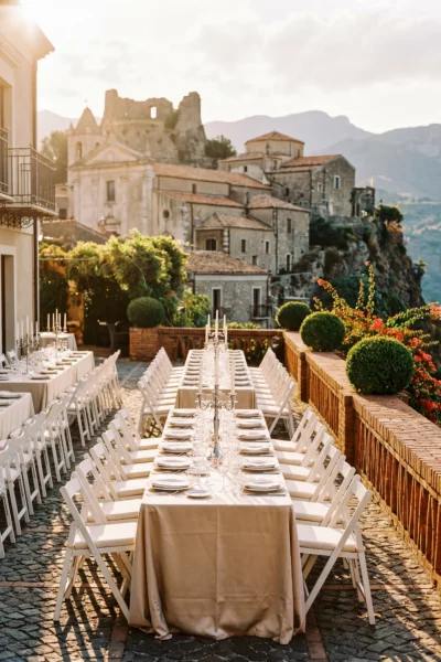 Elegant terrace reception dinner overlooking a Italian village by a french wedding photographer.