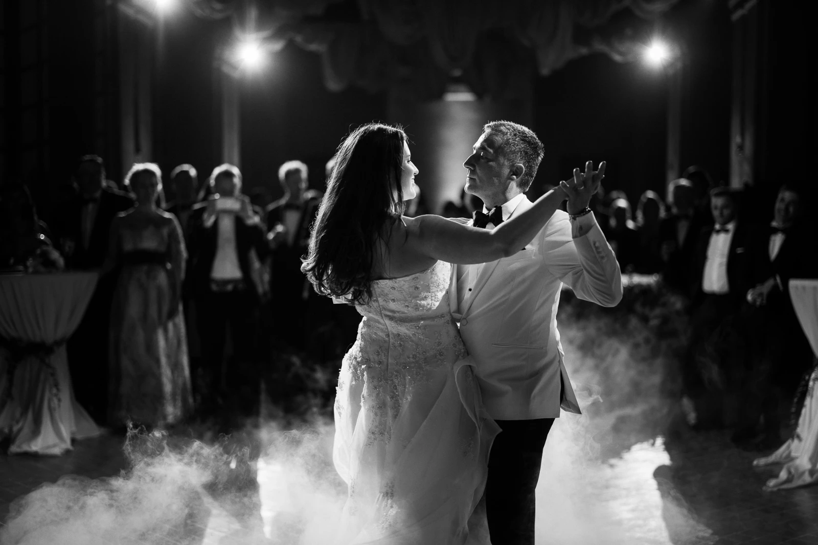 A Cannes wedding photographer captures a romantic first dance amidst low-lying fog in a luxury ballroom.