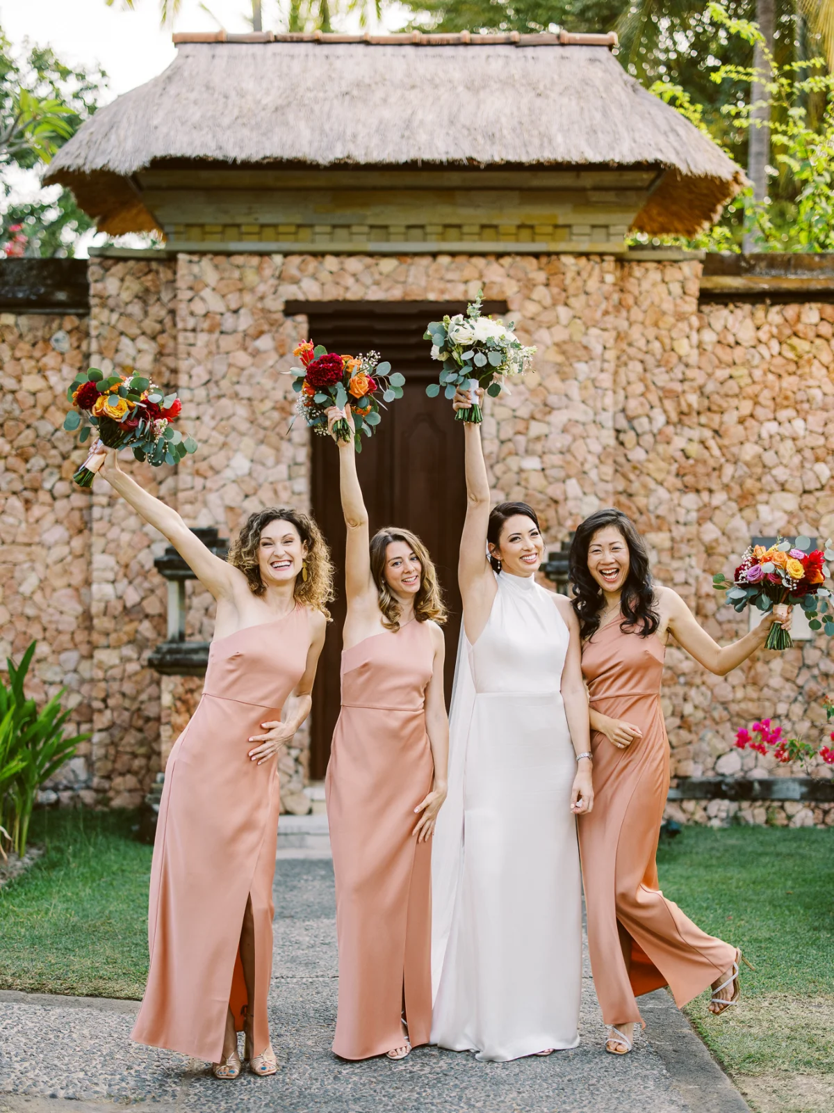 Bride and bridesmaids cheering with bouquets, luxury wedding price.
